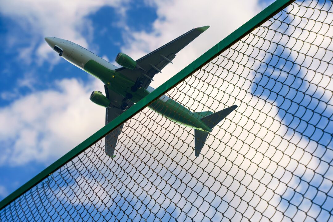 Page-12-Plane-taking-off-against-the-background-of-the-fence-and-the-border-of-the-airport-1080x720.jpeg